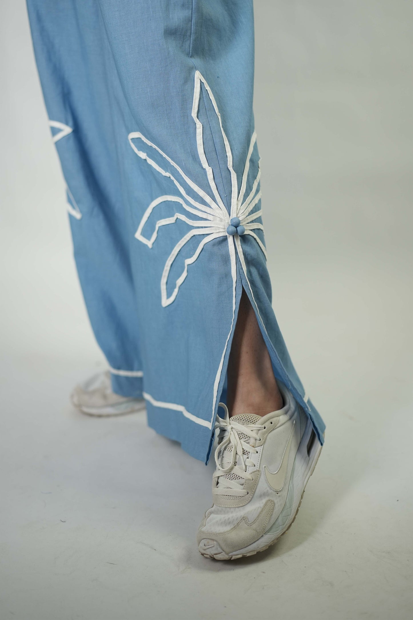 Hand stitched palm tree motif detailing trousers